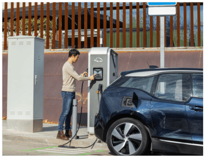 Man Charging Car in Public area